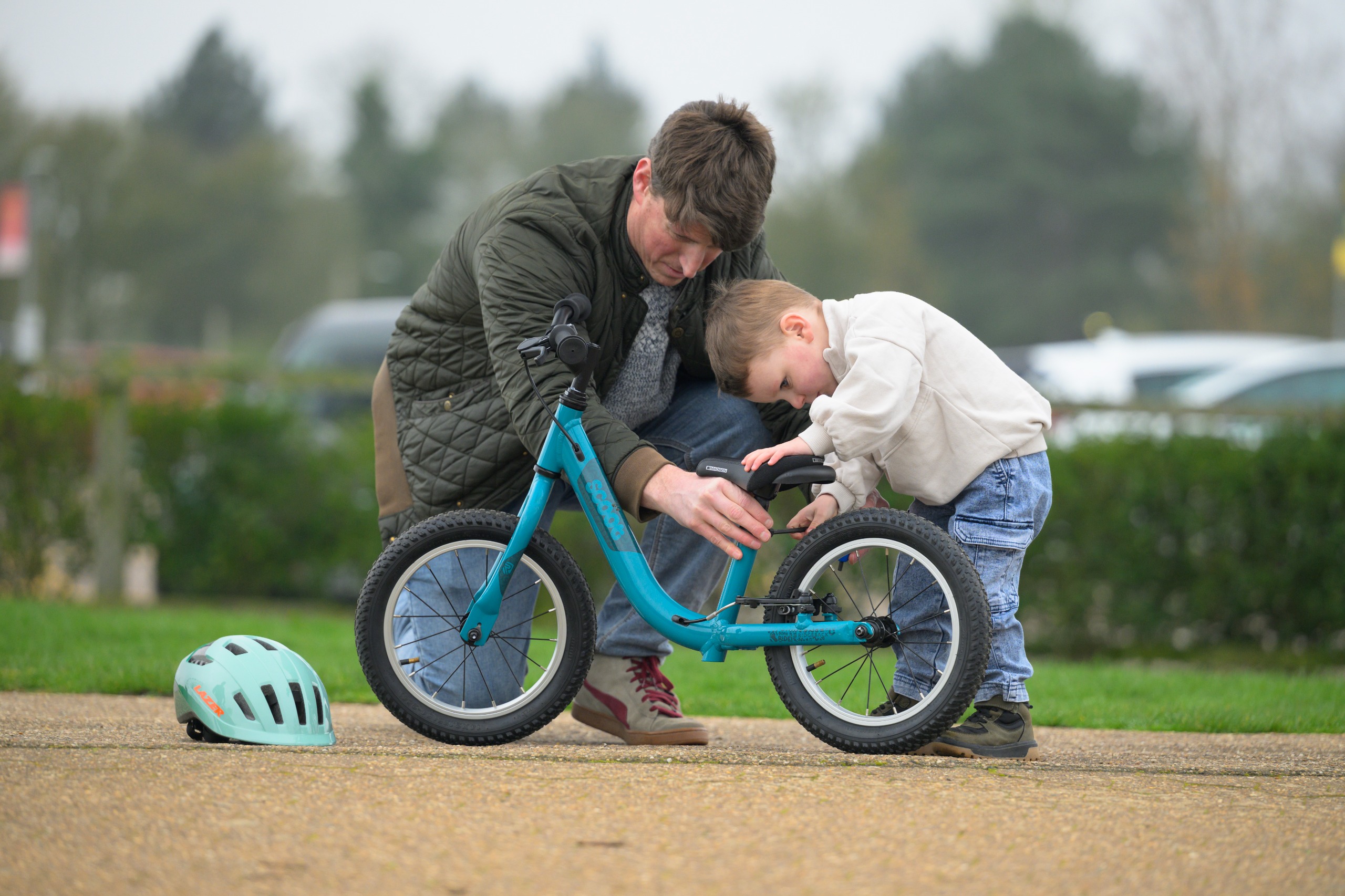 Man pushing a kids on a Ridgeback kids bike